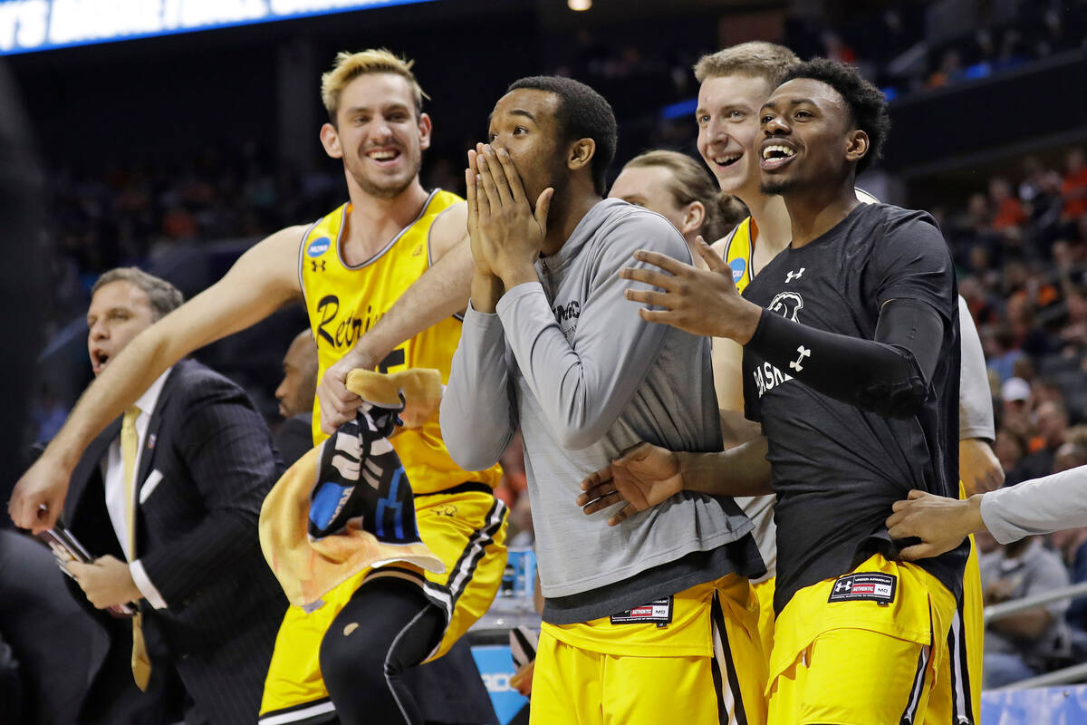UMBC players celebrate a teammate's basket against Virginia during the second half of a first-r ...