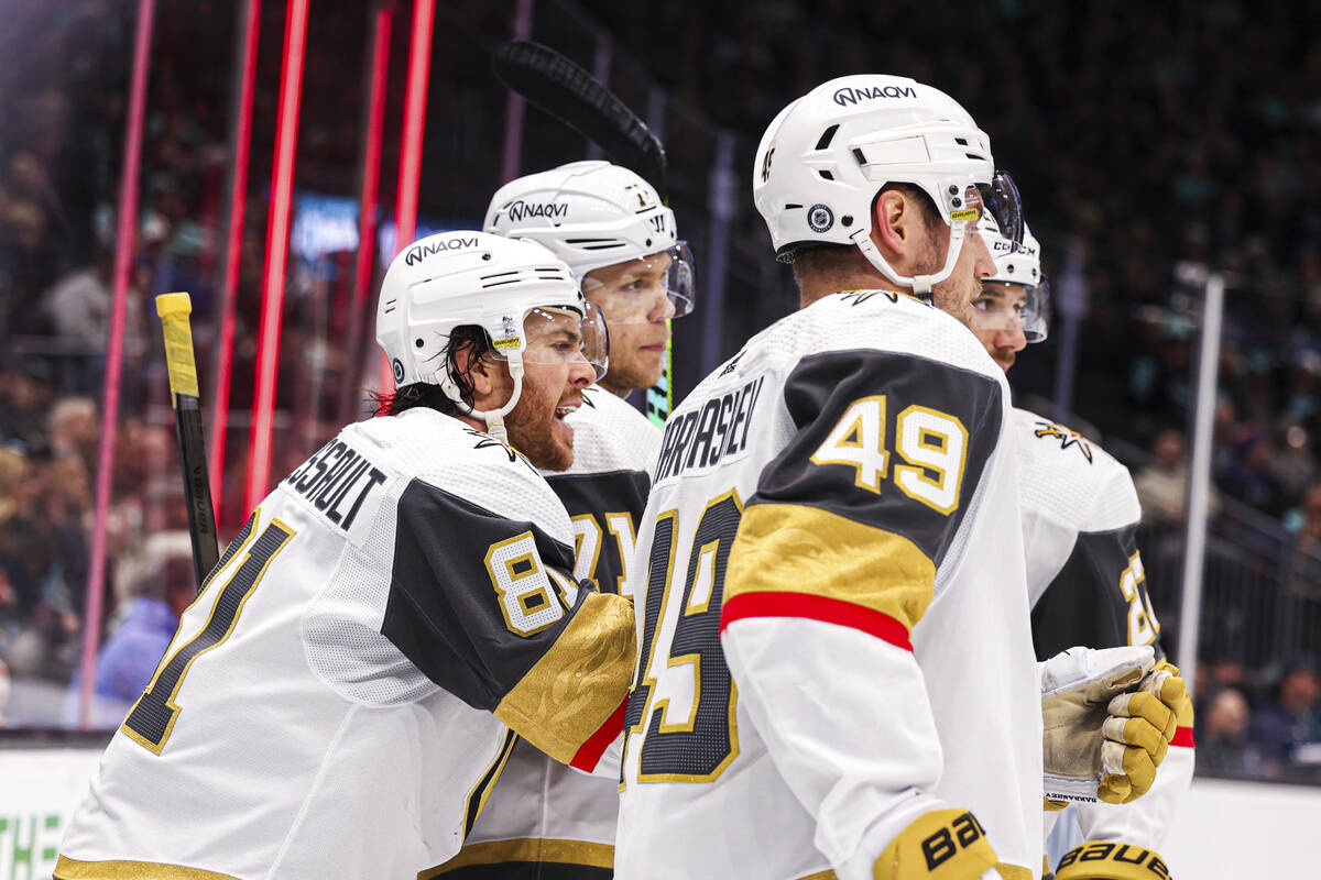 Vegas Golden Knights defenseman Shea Theodore is congratulated by teammates after a goal by rig ...