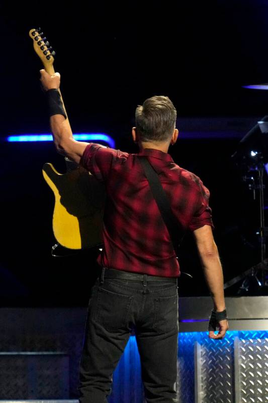 Bruce Springsteen acknowledges the crowd behind him during his concert of Bruce Springsteen and ...
