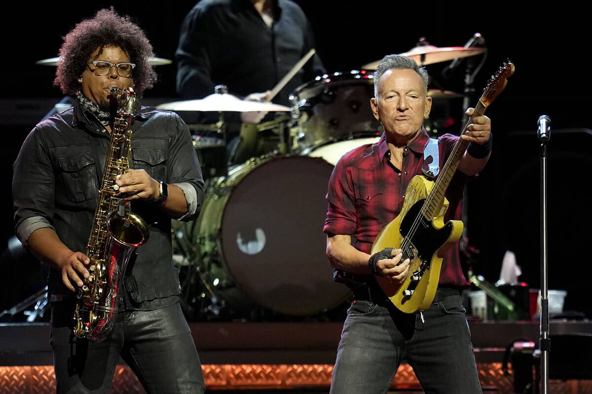 Bruce Springsteen, right, plays his guitar as Jake Clemons plays saxophone on stage during a co ...