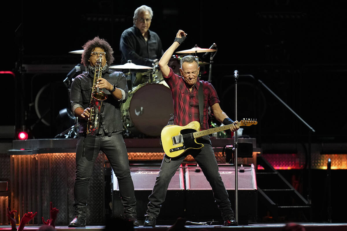 Bruce Springsteen, right, plays his guitar as Jake Clemons, left, plays saxophone as Max Weinbe ...