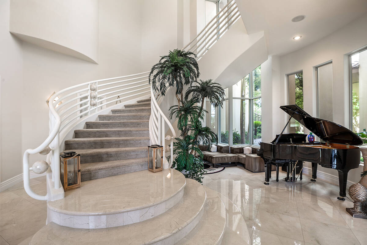 The residence has a long staircase to the second floor. (Luxury Estates International)
