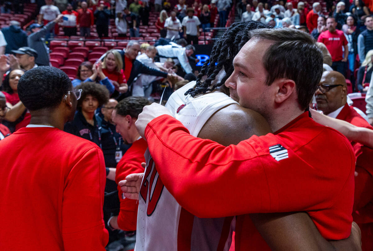 UNLV forward Keylan Boone (20) hugs head coach Kevin Kruger after defeating the San Diego State ...