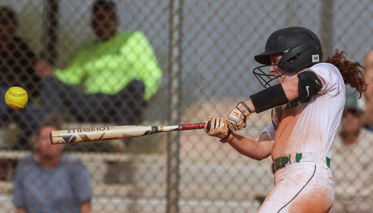 Palo Verde’s Mya Bartlett (18) turns on a pitch during a girls high school softball game ...