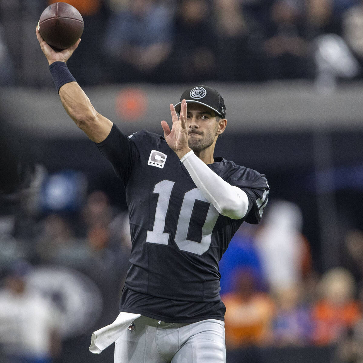 Raiders quarterback Jimmy Garoppolo (10) throw the football on the sideline during the second h ...