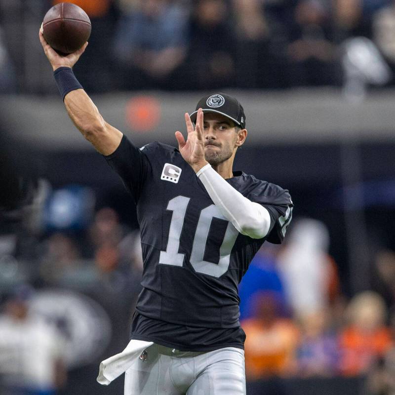 Raiders quarterback Jimmy Garoppolo (10) throw the football on the sideline during the second h ...