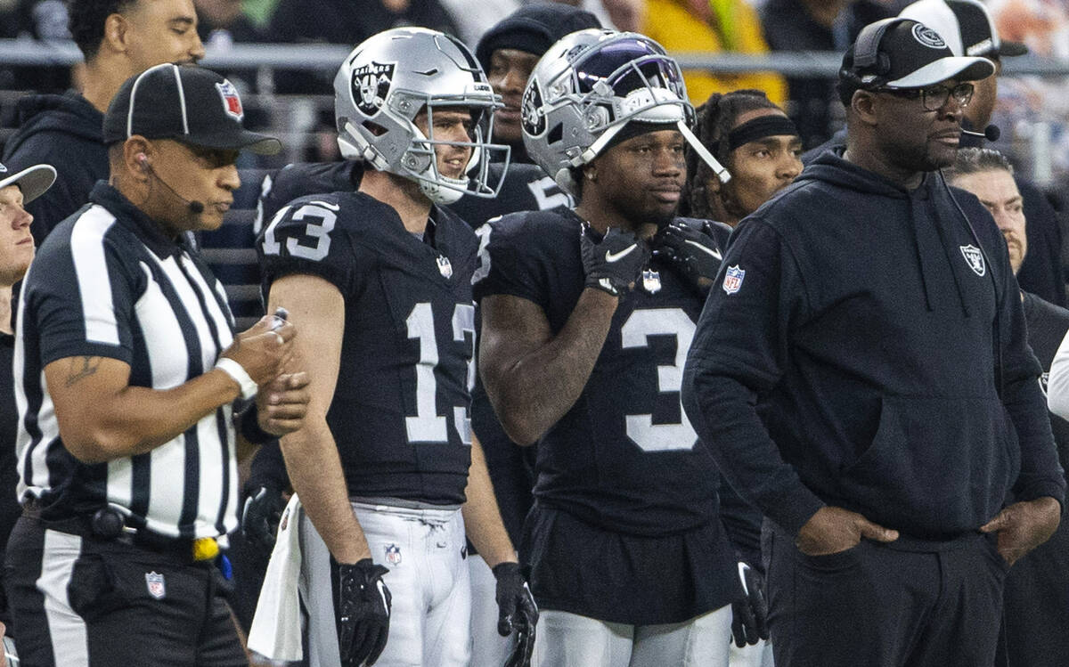 Raiders wide receiver Hunter Renfrow (13) and wide receiver DeAndre Carter (3) look on from the ...