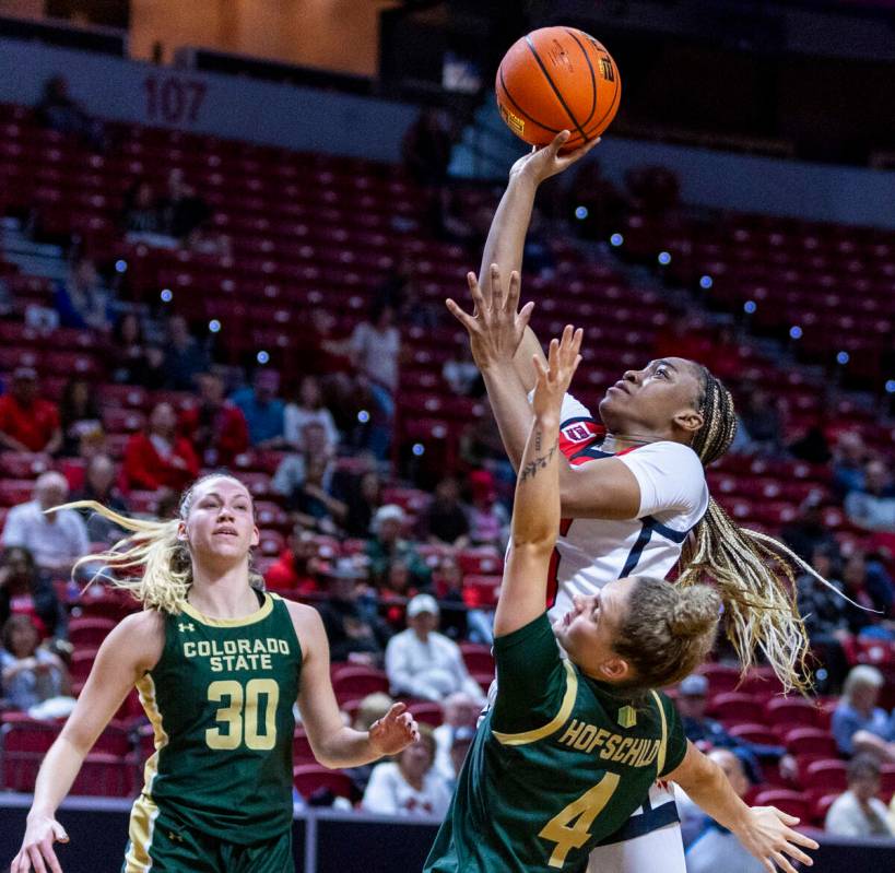UNLV Lady Rebels guard Amarachi Kimpson (33) fights off a block by Colorado State Rams guard Mc ...