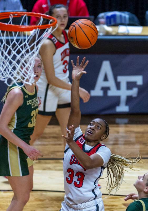 UNLV Lady Rebels guard Amarachi Kimpson (33) lays in the ball past Colorado State Rams guard Mc ...