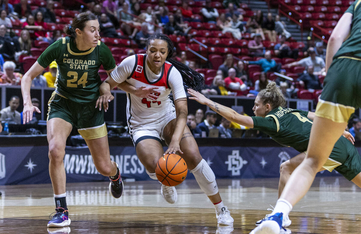 UNLV Lady Rebels forward Alyssa Brown (44) drives the lane hard against the defense of Colorado ...