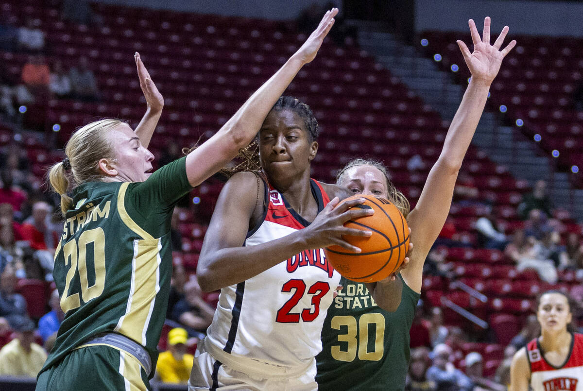 UNLV Lady Rebels center Desi-Rae Young (23) looks to split the defense of Colorado State Rams g ...
