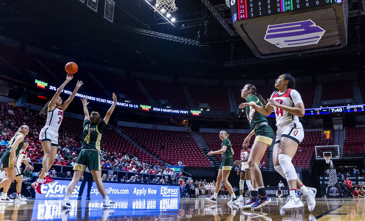 UNLV Lady Rebels guard Kiara Jackson (3) gets off a shot over Colorado State Rams guard McKenna ...