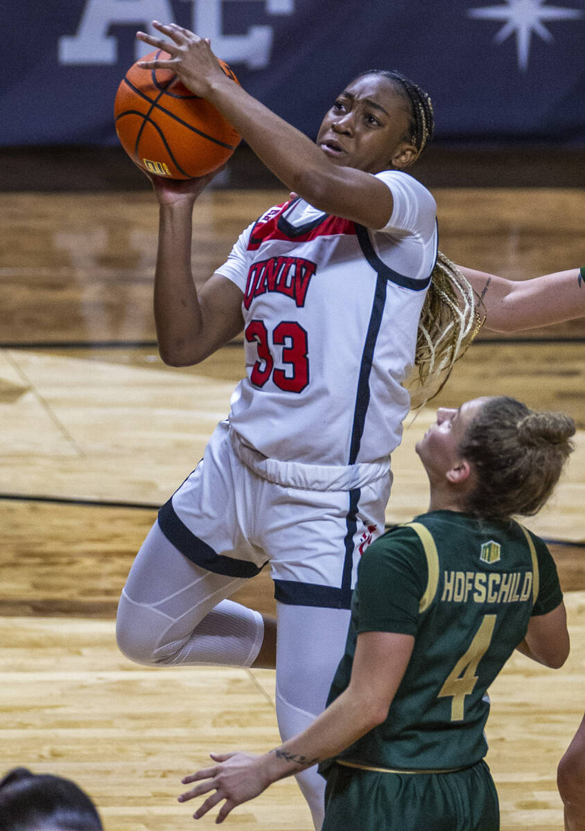 UNLV Lady Rebels guard Amarachi Kimpson (33) posts up for a shot over Colorado State Rams guard ...