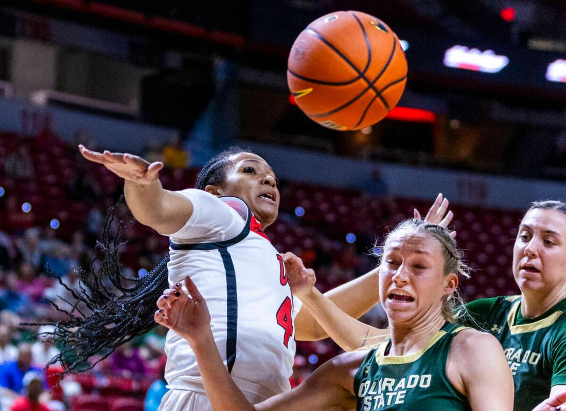 UNLV Lady Rebels forward Alyssa Brown (44) slaps away a loose ball from Colorado State Rams gua ...