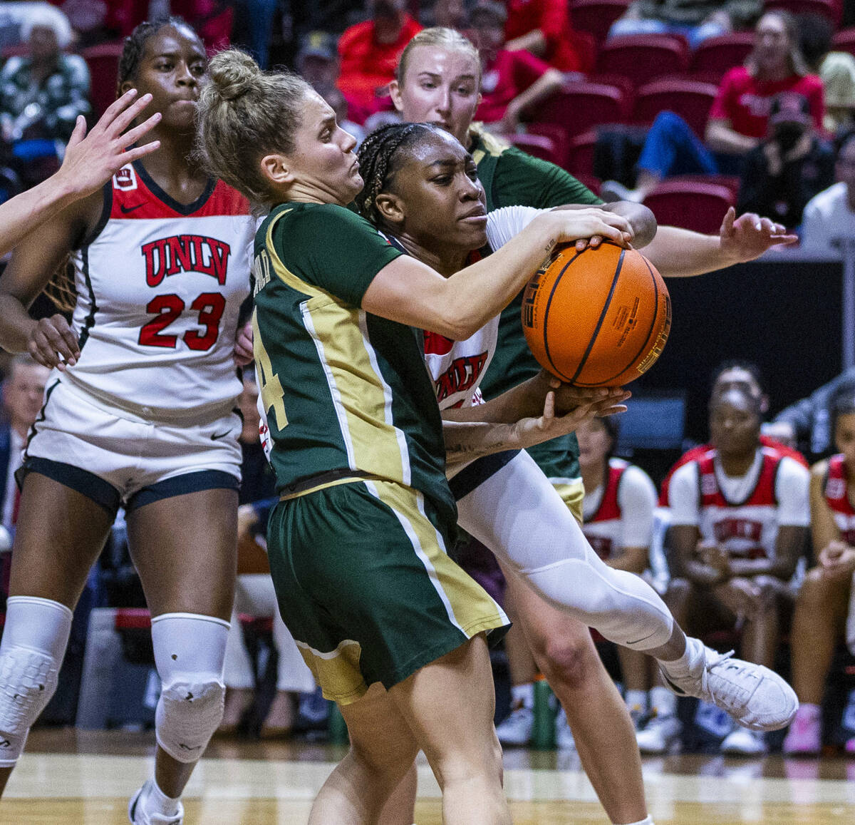 UNLV Lady Rebels guard Amarachi Kimpson (33) has the ball grabbed on a drive by Colorado State ...