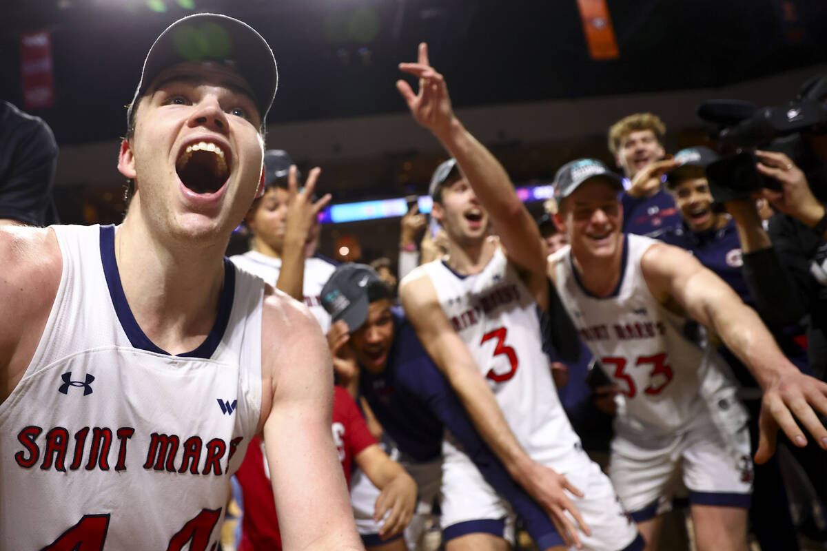St. Mary's Gaels guard Alex Ducas, left, cheers as he marks the bracket after winning an NCAA c ...