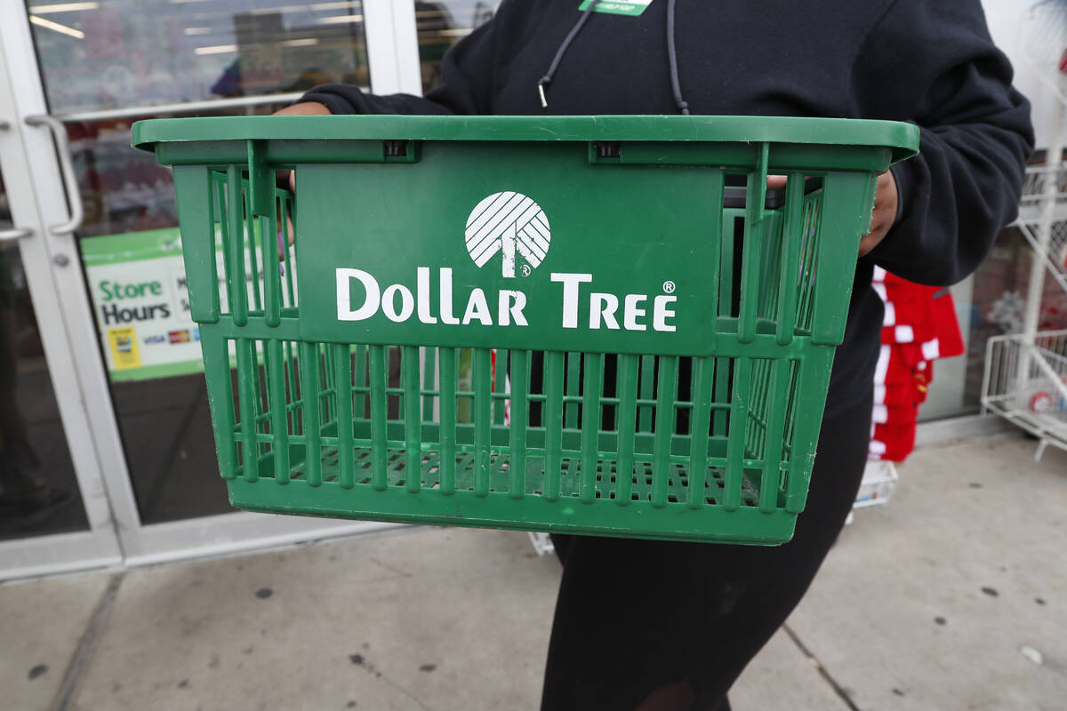 A clerk brings in a shopping basket at a Dollar Tree store in Richland, Miss., Tuesday, Nov. 26 ...