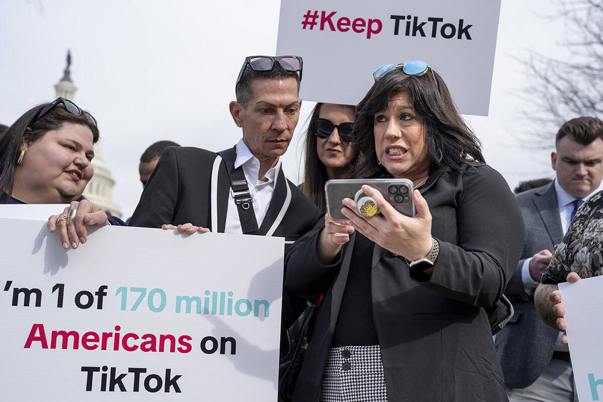 Devotees of TikTok monitor voting at the Capitol in Washington, as the House passed a bill that ...