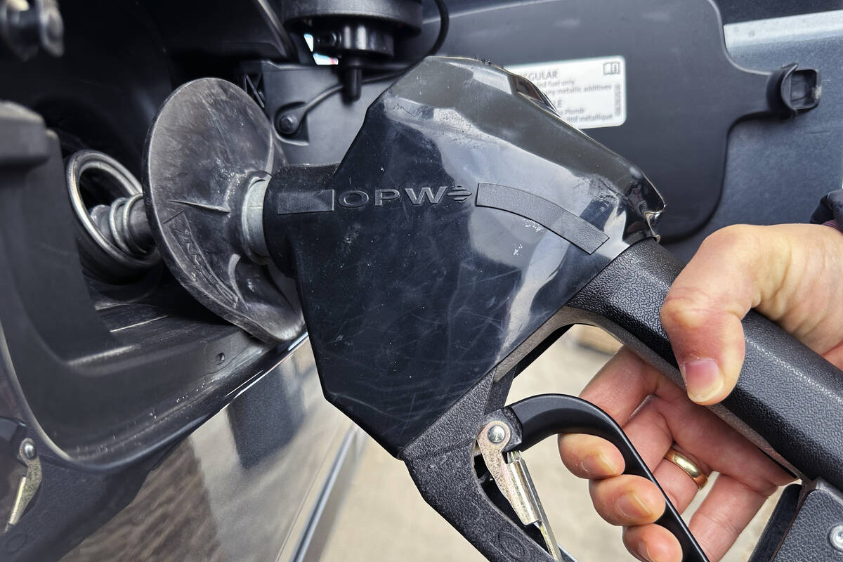 A customer pumps gas at a gas station in Mundelein, Ill., Feb. 8, 2024. A Nebraska woman is fac ...