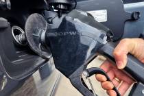 A customer pumps gas at a gas station in Mundelein, Ill., Feb. 8, 2024. A Nebraska woman is fac ...