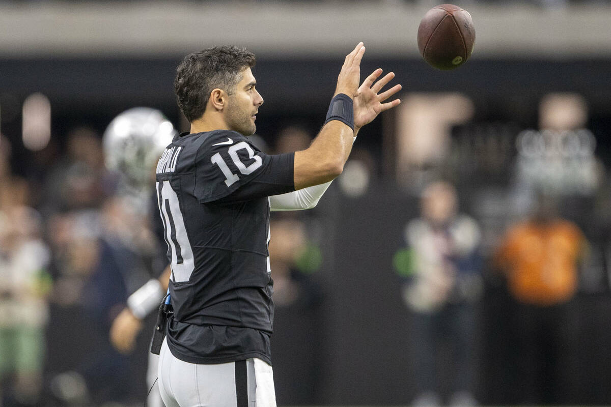 Raiders quarterback Jimmy Garoppolo (10) catches a football during the first half of an NFL gam ...