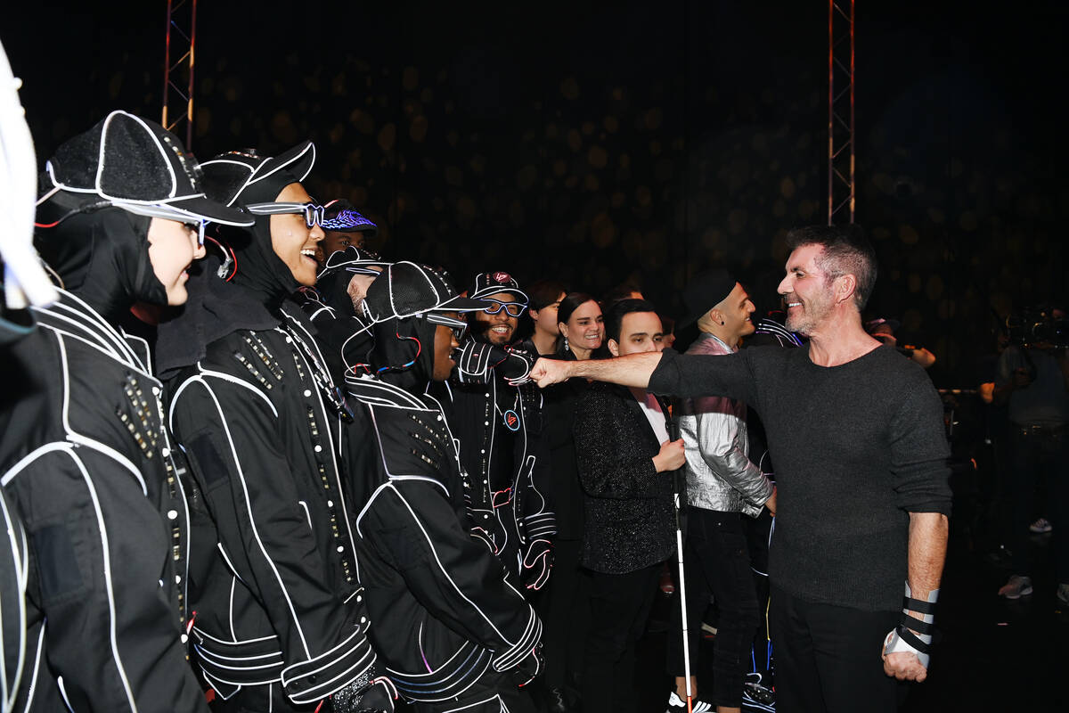 Simon Cowell is shown with the dance troupe Light Balance backstage at "America’s Got Talent ...