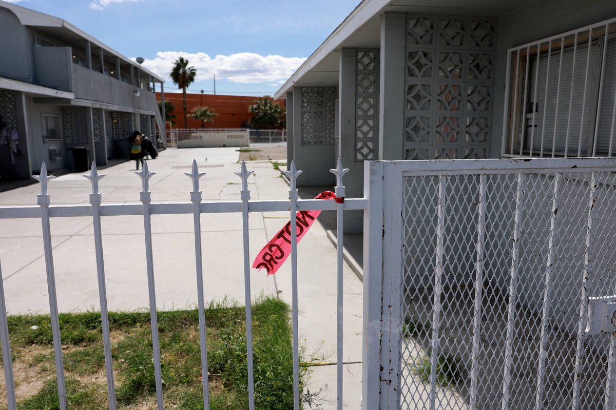 The remains of crime scene tape blow in the wind at an apartment complex in the 2200 block of E ...