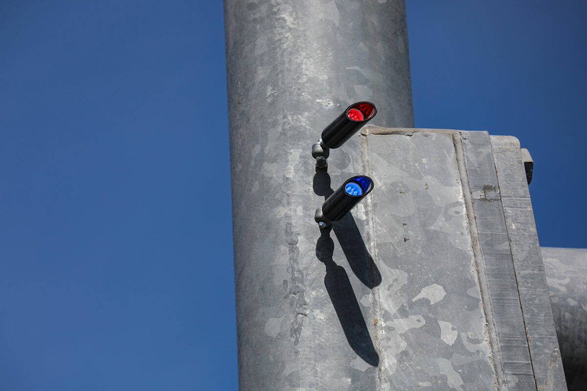 Red light indicators on a street light pole at the intersection of Eastern Avenue and Horizon R ...