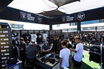 Football fans stop by the Raider Image store in the Modelo tailgate zone before the start of an ...