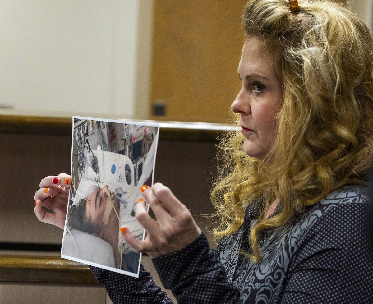 Prosecutor Summer Clarke holds up a photo of Jonathan Lewis, Jr., 17, as his mother, Melissa Re ...