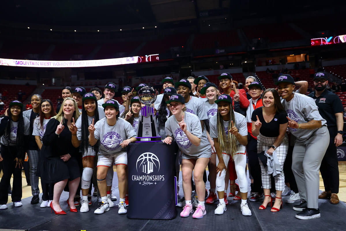 The UNLV Lady Rebels pose for photos with their trophy afte winning an NCAA college basketball ...