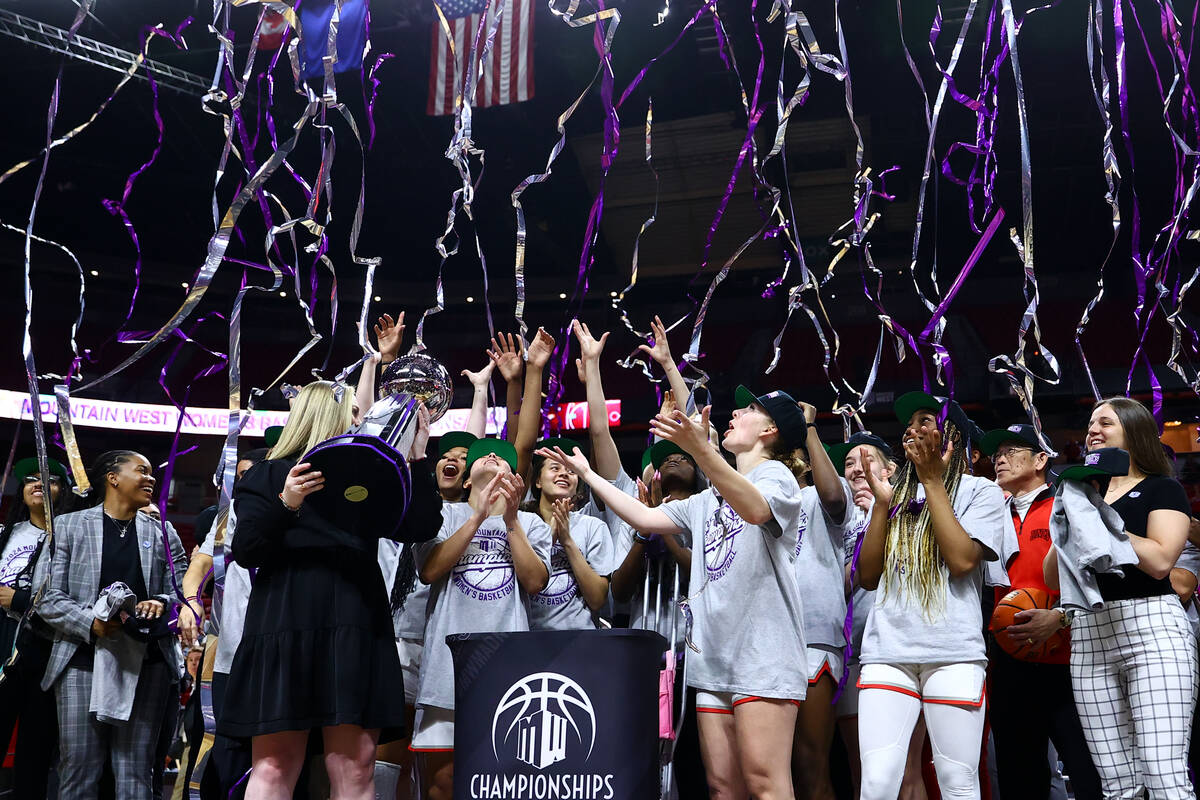 The UNLV Lady Rebels celebrate with their trophy after winning an NCAA college basketball champ ...