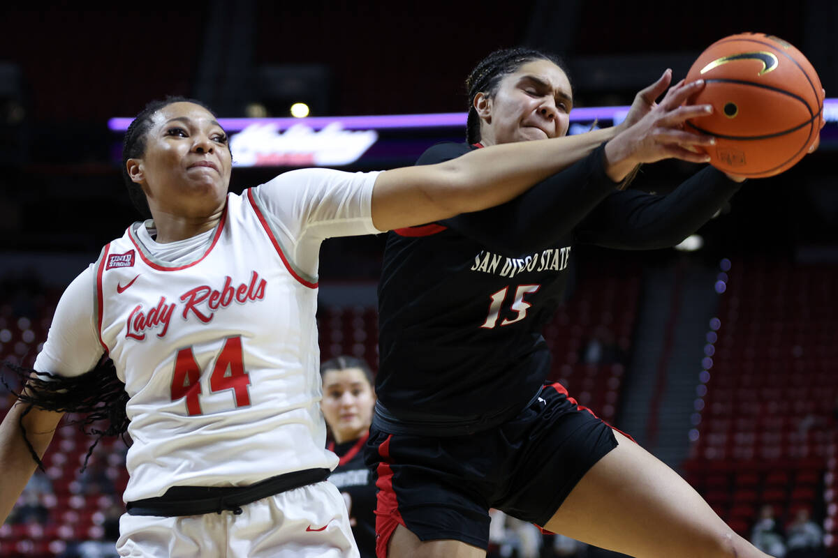 UNLV Lady Rebels forward Alyssa Brown reaches for the ball against San Diego State Aztecs guard ...