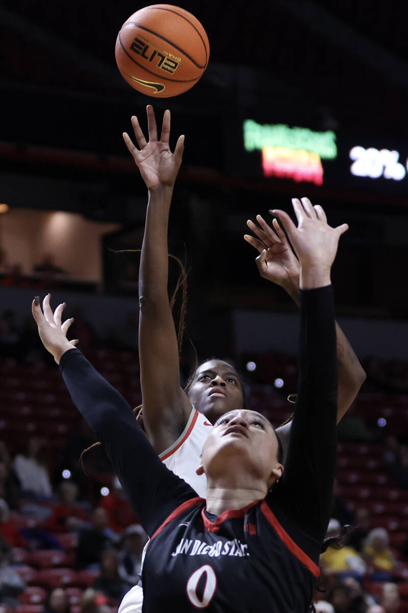 UNLV Lady Rebels center Desi-Rae Young, behind, shoots over San Diego State Aztecs guard Khylee ...