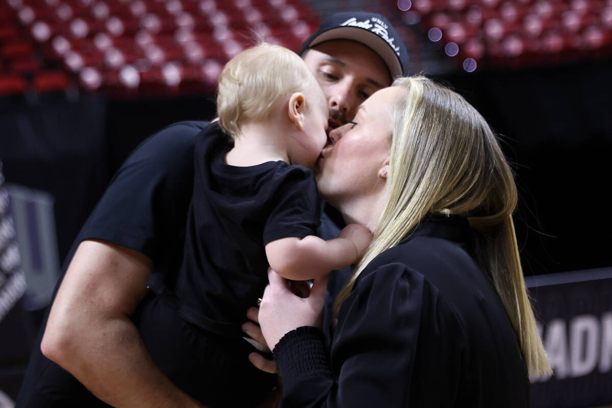 UNLV Lady Rebels head coach Lindy La Rocque kisses her daughter, Ellie Cunningham, who is held ...