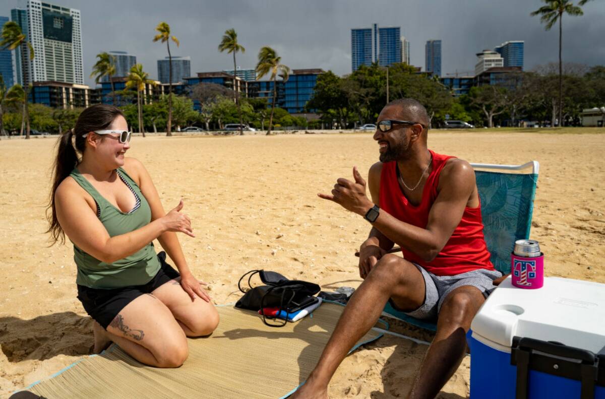 Mignon Walter, left, of Honolulu, exchanges a shaka with Marcus Grayson, of Las Vegas, at Ala M ...