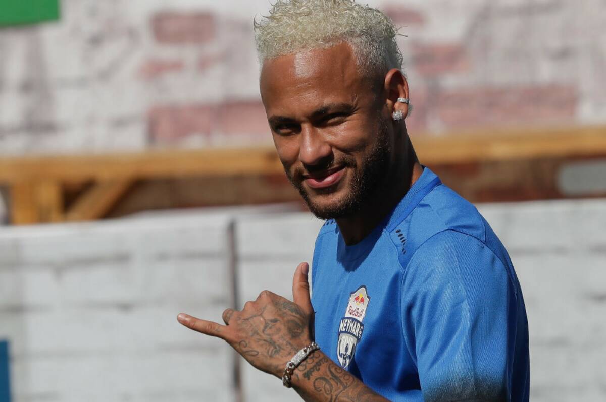 Brazilian soccer player Neymar flashes fans the Hawaiian "shaka" hand sign during the Neymar Jr ...