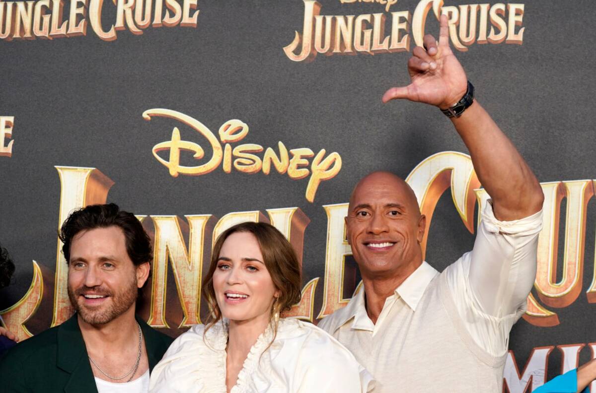 Dwayne Johnson, right, a cast member in "Jungle Cruise," flashes the Hawaiian "shaka" hand sign ...