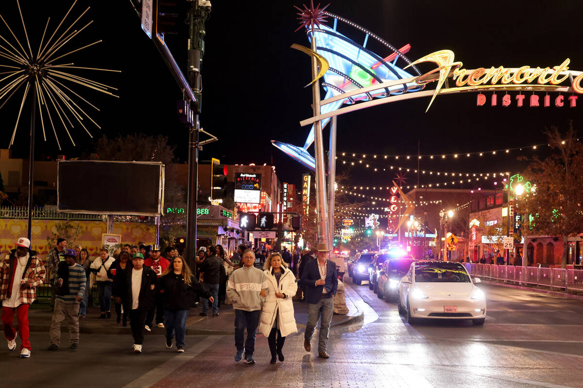 New Year’s Eve revelers make their way across Las Vegas Boulevard to the Time of Your Li ...