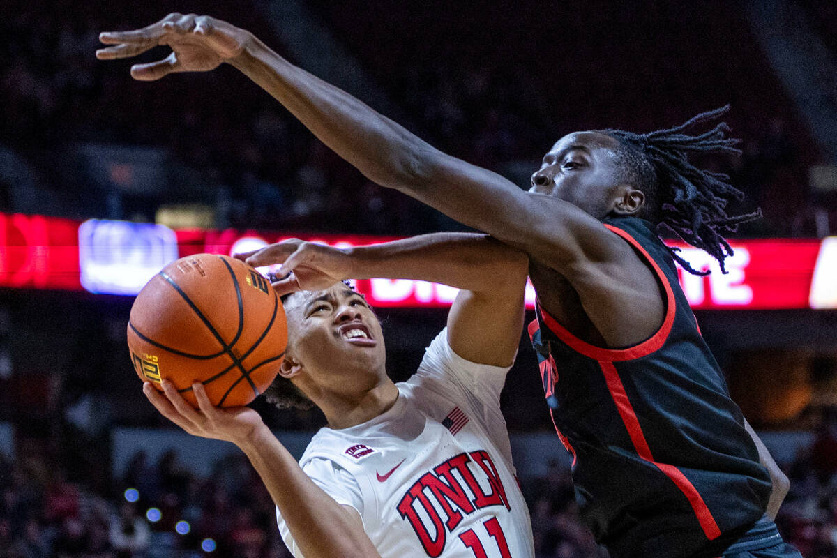 UNLV Rebels guard Dedan Thomas Jr. (11) looks to shoot against San Diego State Aztecs forward J ...