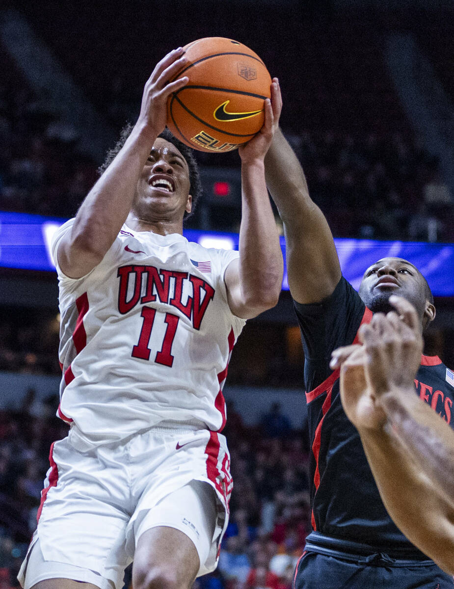 UNLV Rebels guard Dedan Thomas Jr. (11) battles to the rim against San Diego State Aztecs guard ...