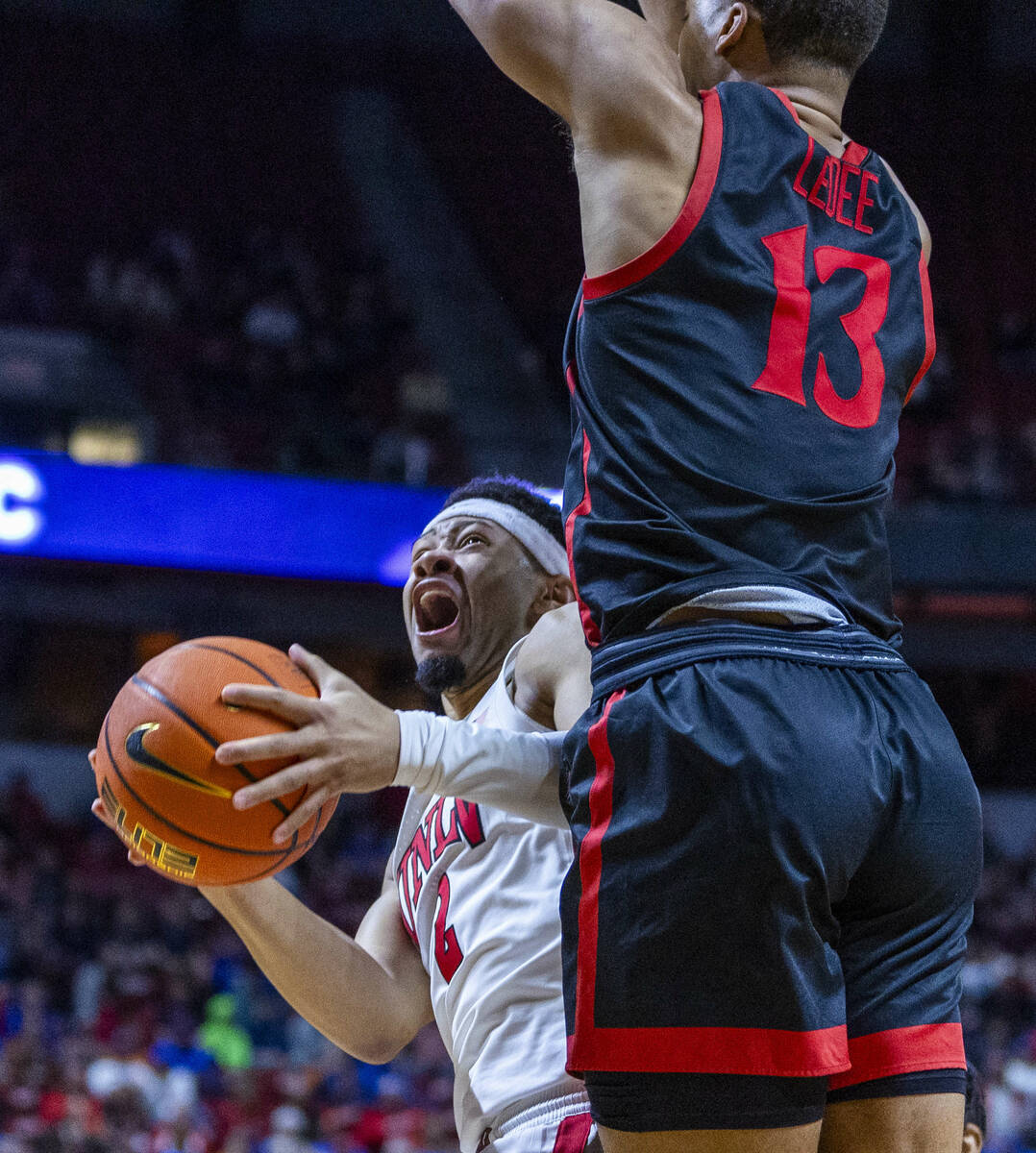 UNLV Rebels guard Justin Webster (2) looks for a shot beneath San Diego State Aztecs forward Ja ...