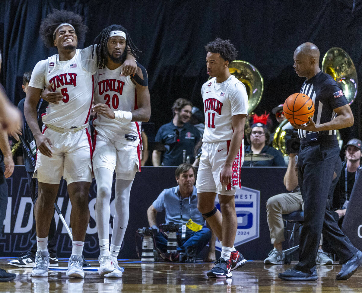 UNLV Rebels forward Rob Whaley Jr. (5) is injured and helped off the court by teammate forward ...