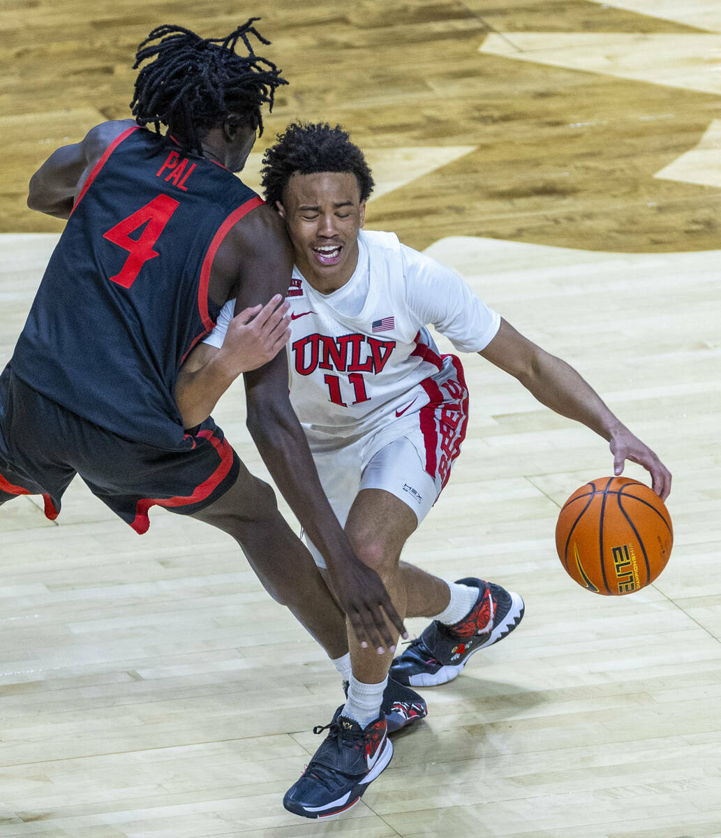 UNLV Rebels guard Dedan Thomas Jr. (11) collides with San Diego State Aztecs forward Jay Pal (4 ...