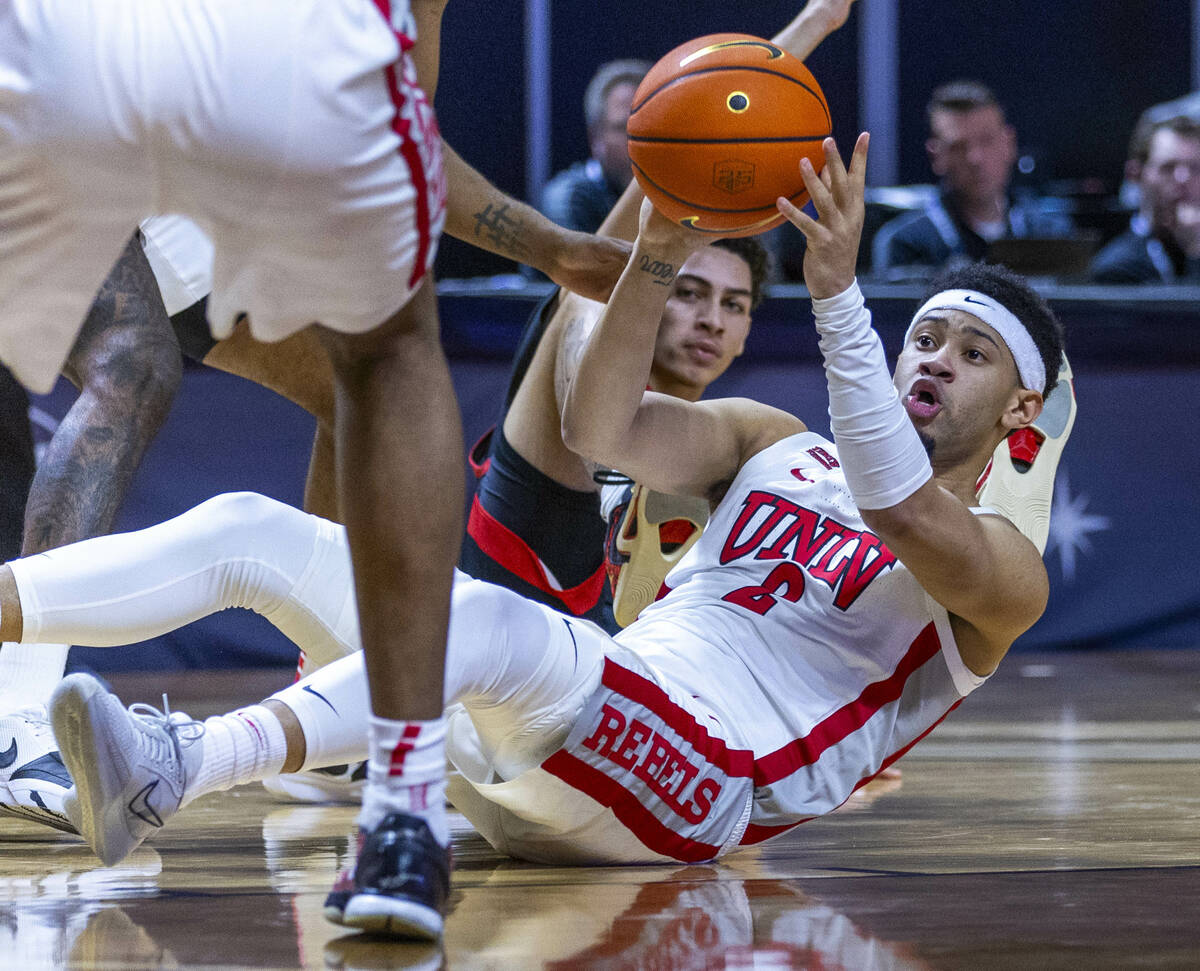 UNLV Rebels guard Justin Webster (2) looks to pass from the floor after a loose ball against th ...