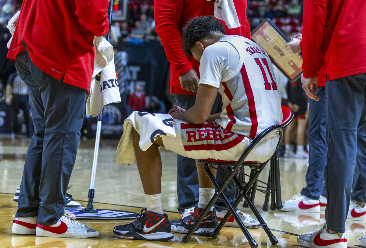 UNLV Rebels guard Dedan Thomas Jr. (11) sits totally spent on the court on a late timeout again ...