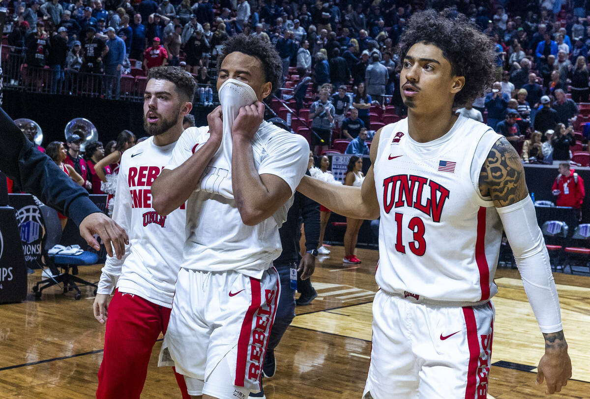 UNLV Rebels guard Dedan Thomas Jr. (11) is dejected while being escorted off the court by teamm ...