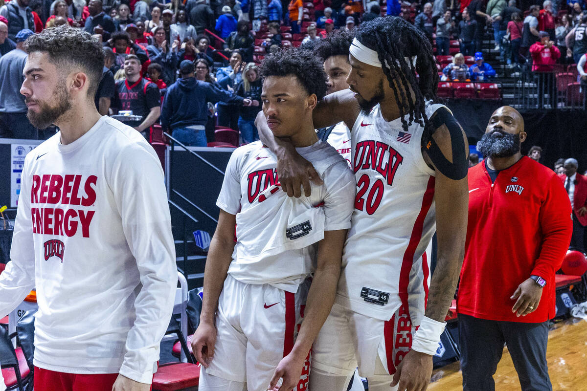 UNLV Rebels guard Dedan Thomas Jr. (11) is consoled by teammate forward Keylan Boone (20) after ...