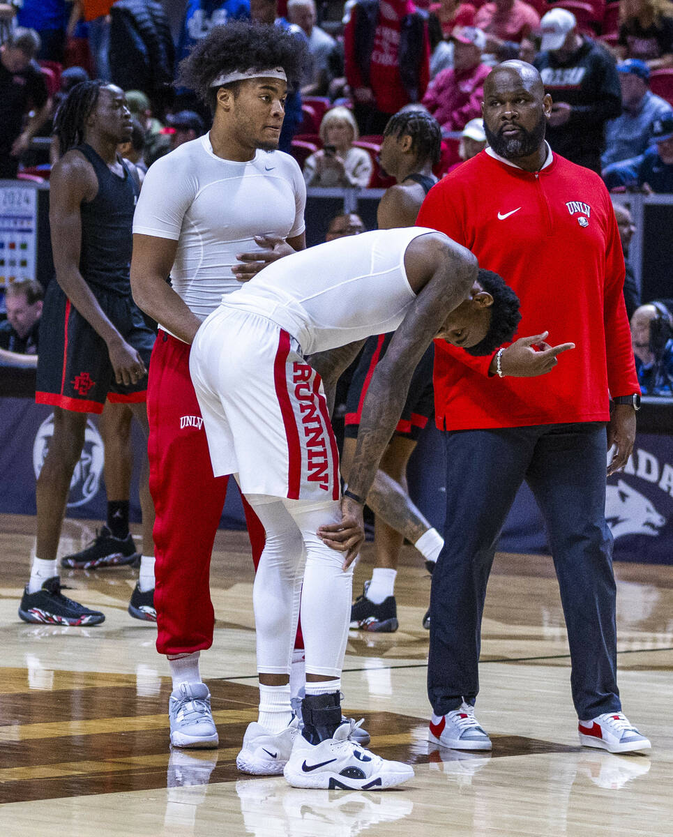 UNLV Rebels forward Kalib Boone (10) looks to an injured ankle as he attempts to warm up agains ...
