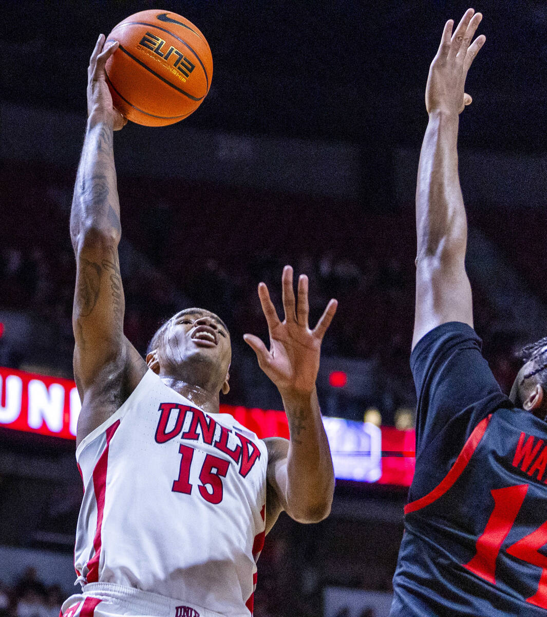 UNLV Rebels guard Luis Rodriguez (15) looks to shoot over San Diego State Aztecs guard Reese Wa ...